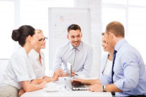 business team having meeting in office friendly business team having meeting in office